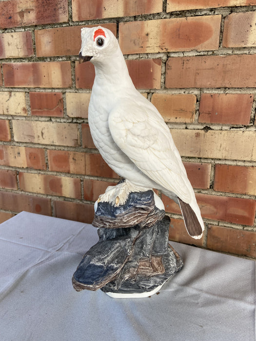 PAIR OF PORCELAIN ARCTIC BIRD STATUES ON ROCKS