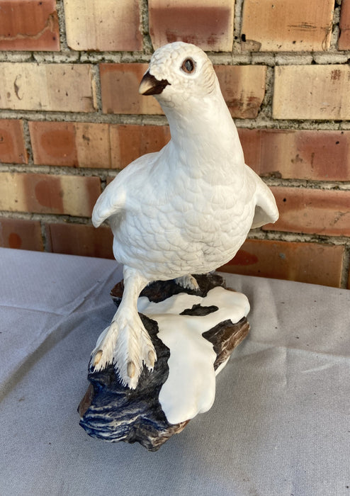 PAIR OF PORCELAIN ARCTIC BIRD STATUES ON ROCKS