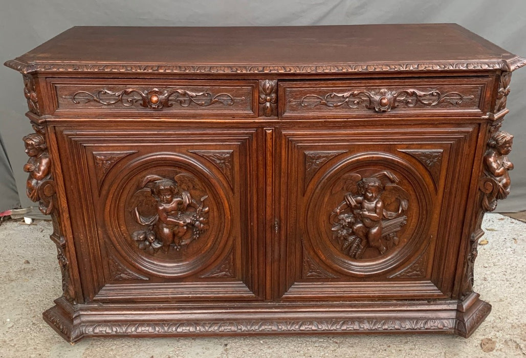 NICELY CARVED DARK OAK SERVER WITH PUTTI