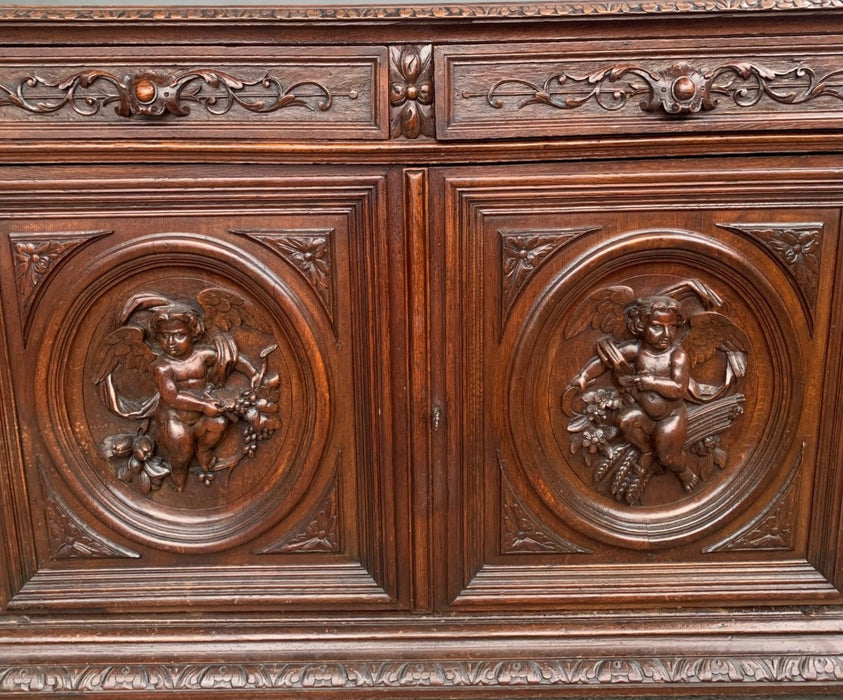 NICELY CARVED DARK OAK SERVER WITH PUTTI