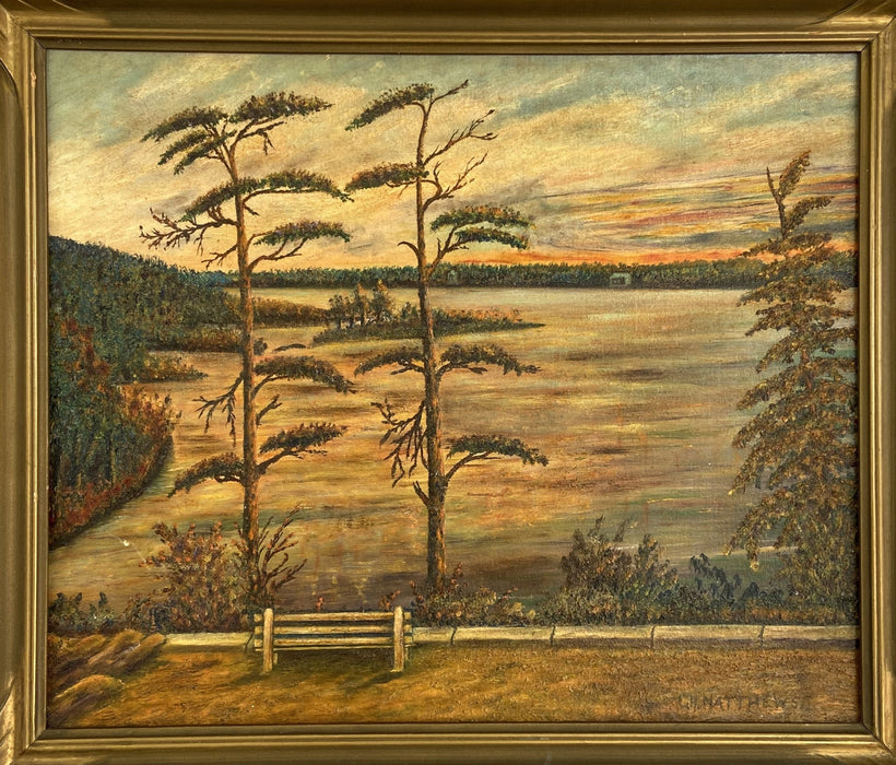 OIL PAINTING OF A LAKE SHORE WITH TREES AND A BENCH BY C. H. MATTHEWS