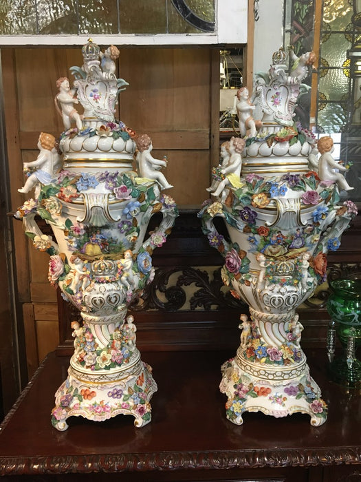 PAIR OF HUGE DRESDEN URNS WITH FLOWERS AND CHERIBUM