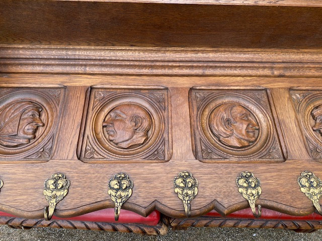 CARVED OAK WALL SHELF WITH PORTRAITS IN PROFILE