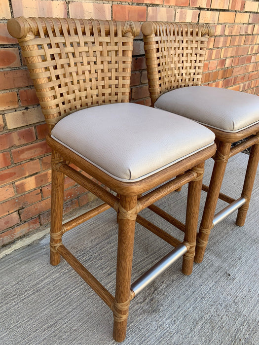 PAIR OF MCGUIRE BY BAKER RATTAN COUNTER STOOLS