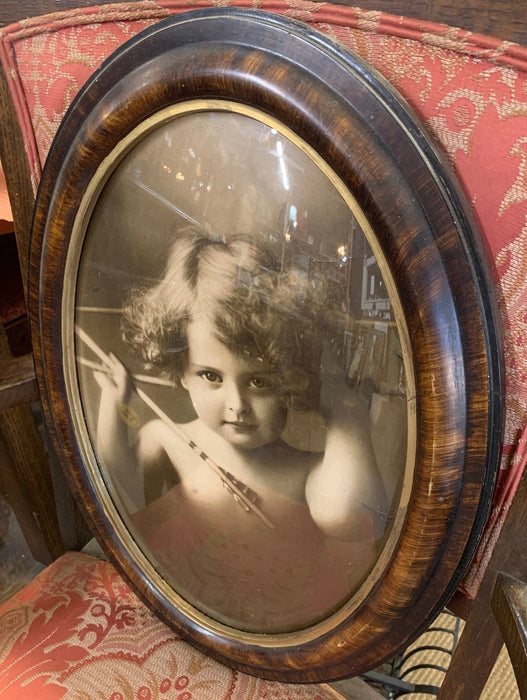 ANTIQUE OVAL GIRL CHERUB PICTURE IN FAUX WOOD FRAME WITH CONVEX GLASS