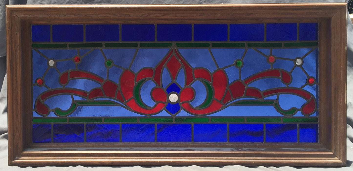 LONG RED AND BLUE STAINED GLASS TRANSOM WINDOW WITH RONDELL