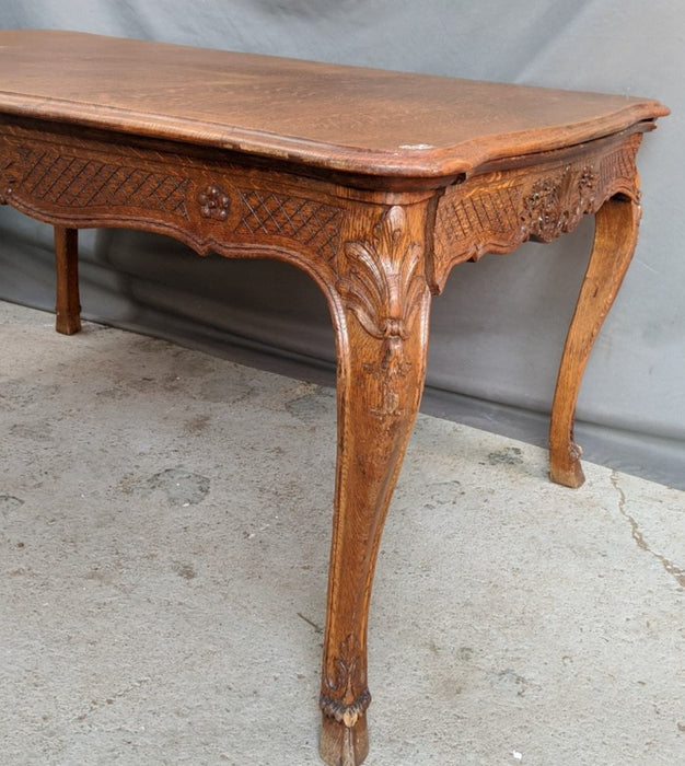LIEGES OAK DINING TABLE WITH INCISED CARVING AND HOOFED FEET