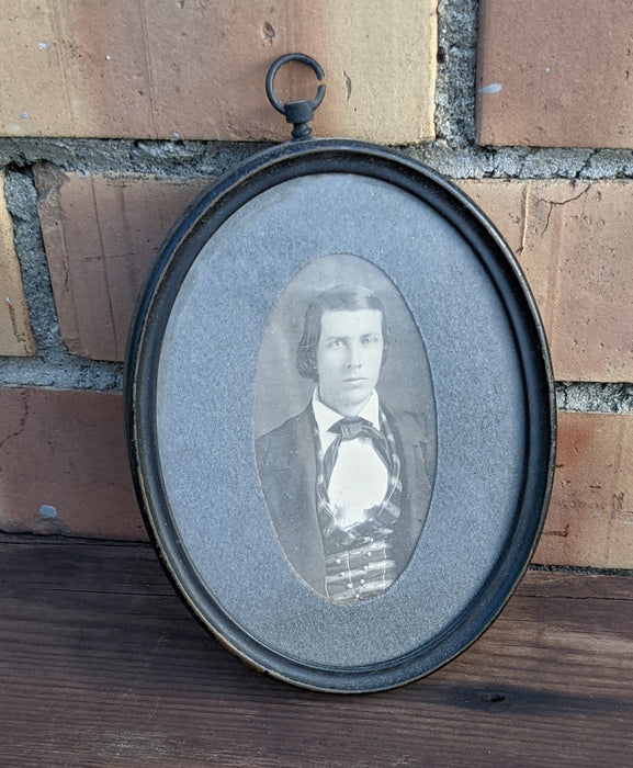 PAIR OF TINY PORTRAITS IN OVAL METAL FRAMES