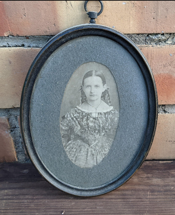 PAIR OF TINY PORTRAITS IN OVAL METAL FRAMES