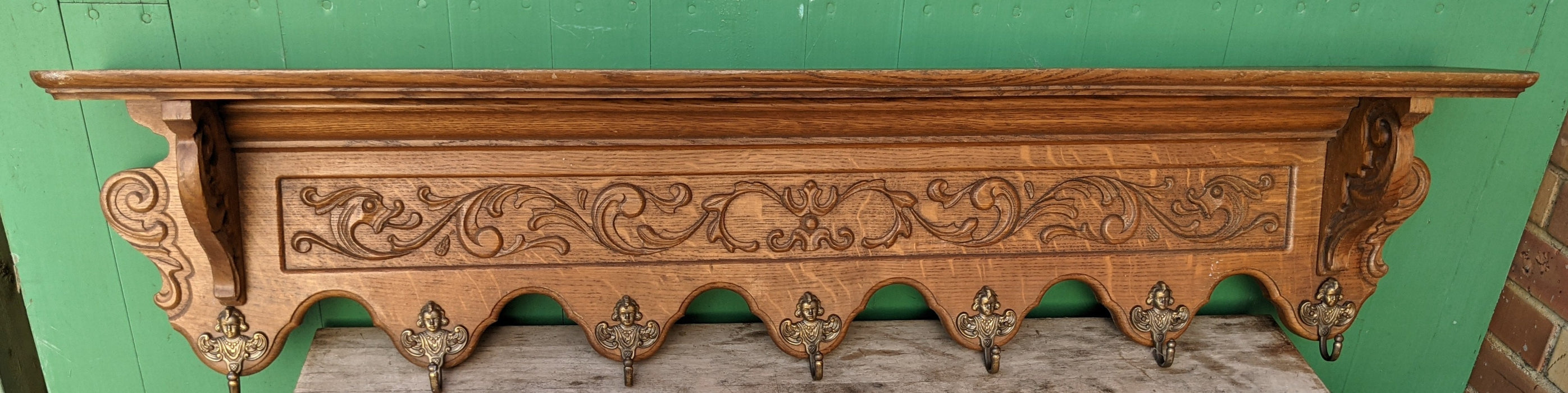 LONG FOLIATE DESIGN OAK WALL SHELF WITH BRASS ANGEL HOOKS