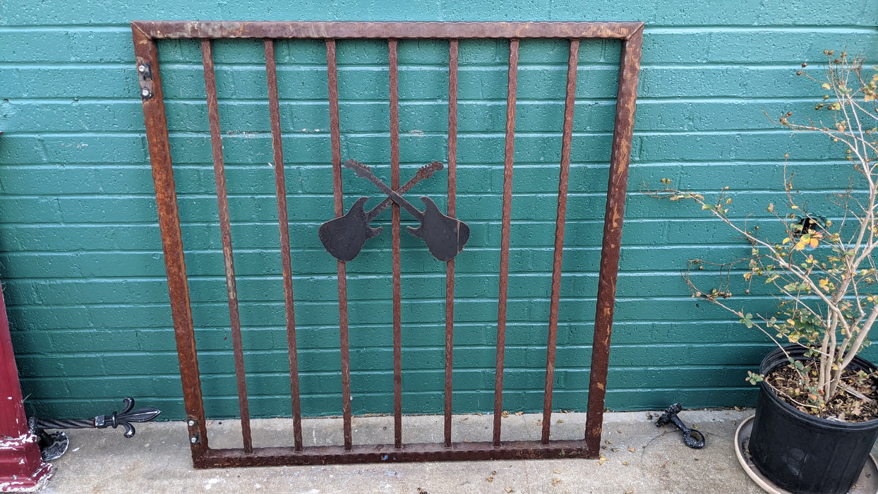 SMALL IRON GATE WITH CROSSED GUITARS