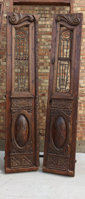 PAIR OF TALL CARVED DOORS WITH IRON INSETS IN FRAME