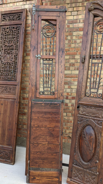 PAIR OF TALL CARVED DOORS WITH IRON INSETS IN FRAME