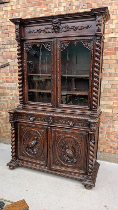 LARGE CARVED OAK BOOKCASE WITH GREENMAN AND MYTHOLOGICAL FIGURES