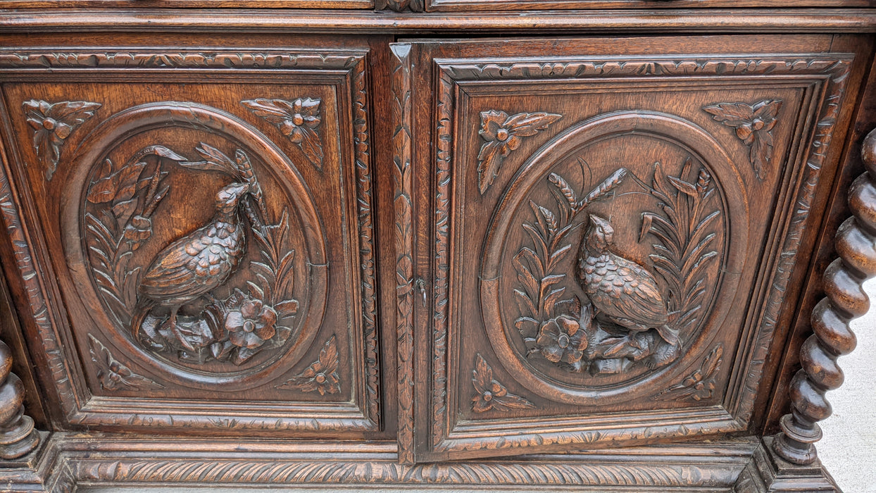 LARGE CARVED OAK BOOKCASE WITH GREENMAN AND MYTHOLOGICAL FIGURES