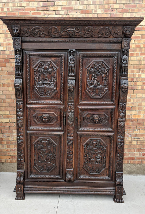 ORNATELY CARVED ARMOIRE WITH PAW FEET