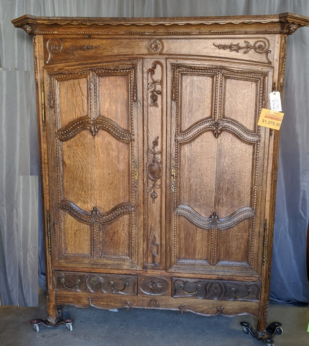 ORNATELY CARVED LOUIS XV OAK ARMOIRE WITH CHERUB HEADS