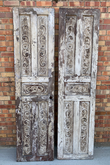 PAIR OF PAINTED AND CARVED RUSTIC DOORS