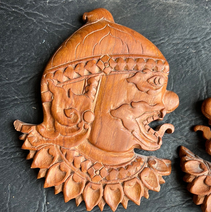 PAIR OF ASIAN HAND CARVED PROFILE PLAQUES WITH TONGUES OUT