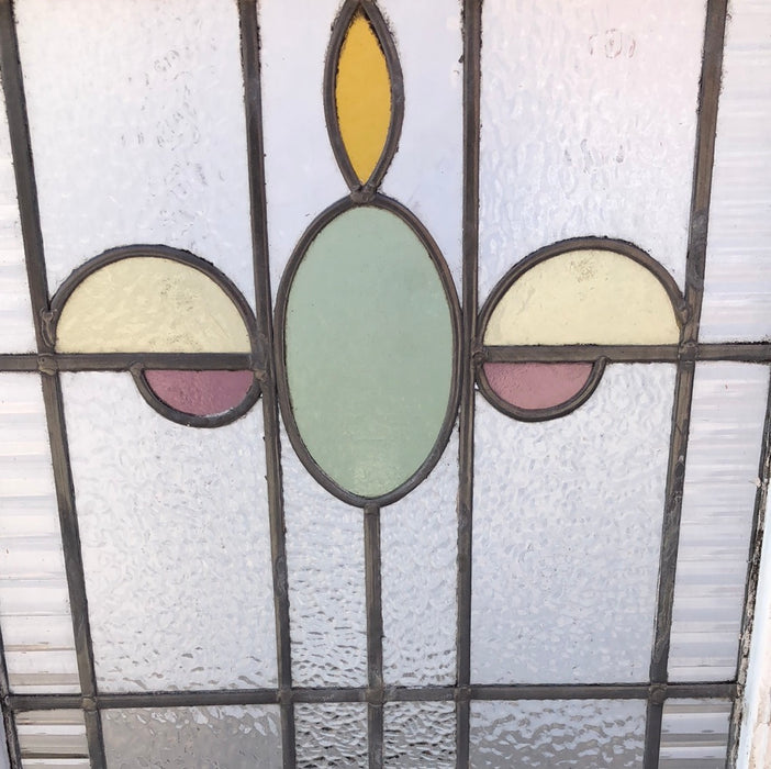 MEDIUM VERTCAL STAINED GLASS WINDOW WITH GREEN OVAL AND YELLOW HALF OVALS