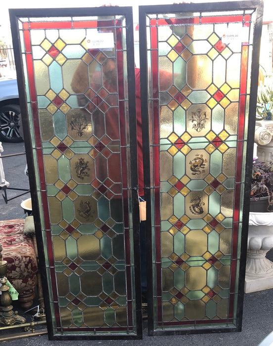 PAIR OF TALL NARROW STAINED GLASS WINDOWS HAND PAINTED WITH LIONS, DRAGONS, TORCHES