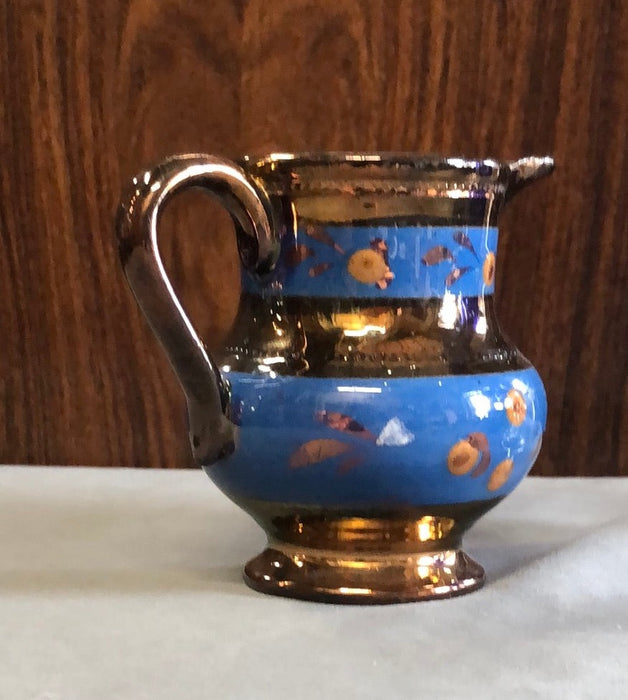 SMALL COPPER LUSTER PITCHER WITH 2 BLUE FLORAL BANDS