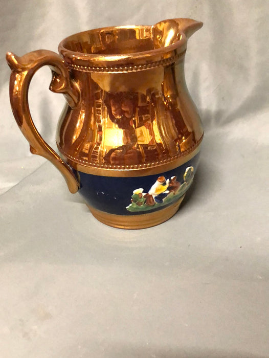 COPPER LUSTER PITCHER WITH MAN AND DOG