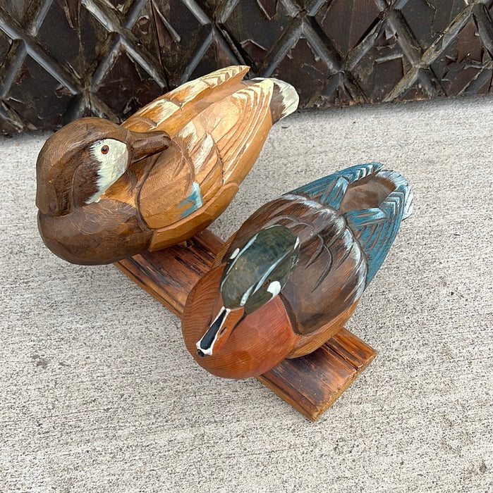 CARVED DUCKS ON LIMB