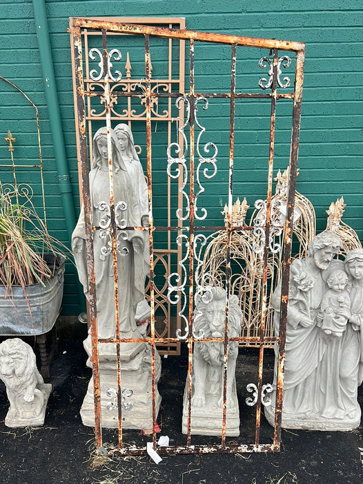 TALL IRON GATE WITH SLANTED TOP AND ALUMINUM APPLIQUE