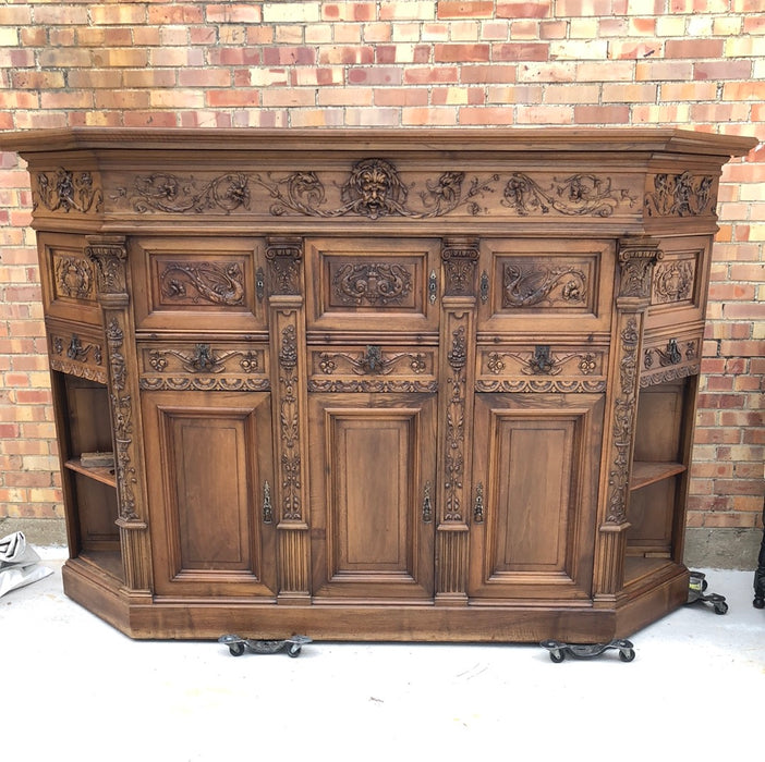 WALNUT GRIFFIN CARVED CABINET WITH CANTED ENDS