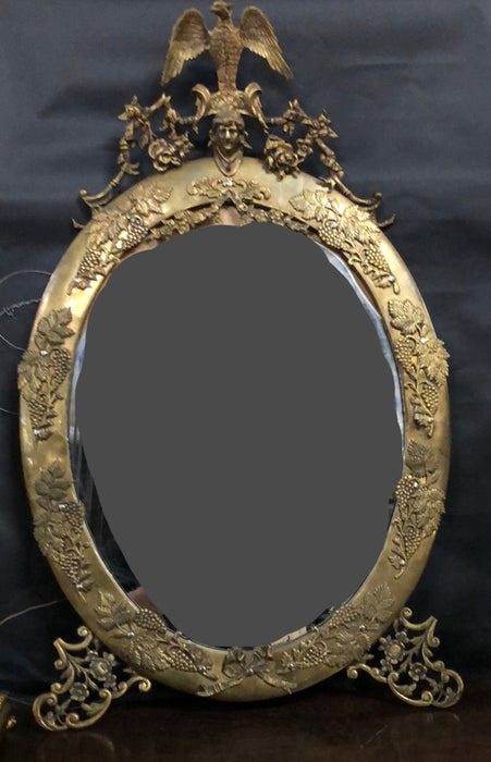 BRASS OVAL FRAME WITH EAGLE LADY'S HEAD AND GRAPE MOTIF