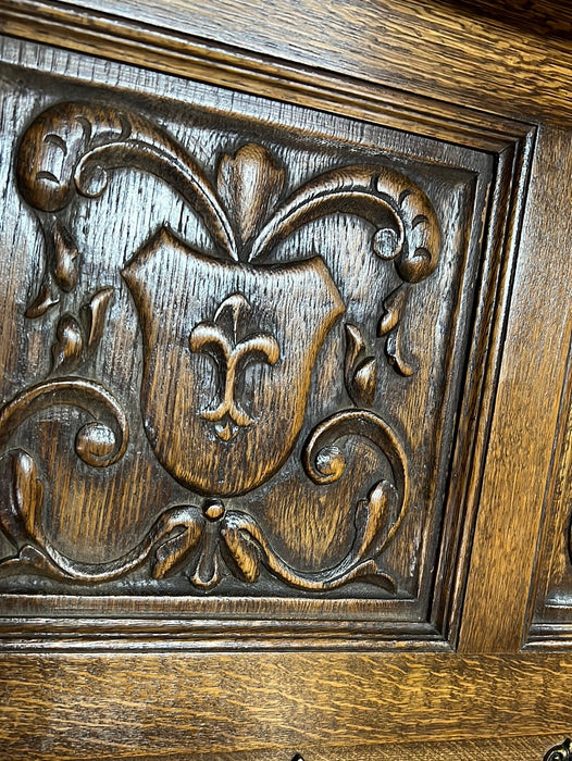 OAK CROSS AND FIGURAL CARVING WALL SHELF WITH HOOKS