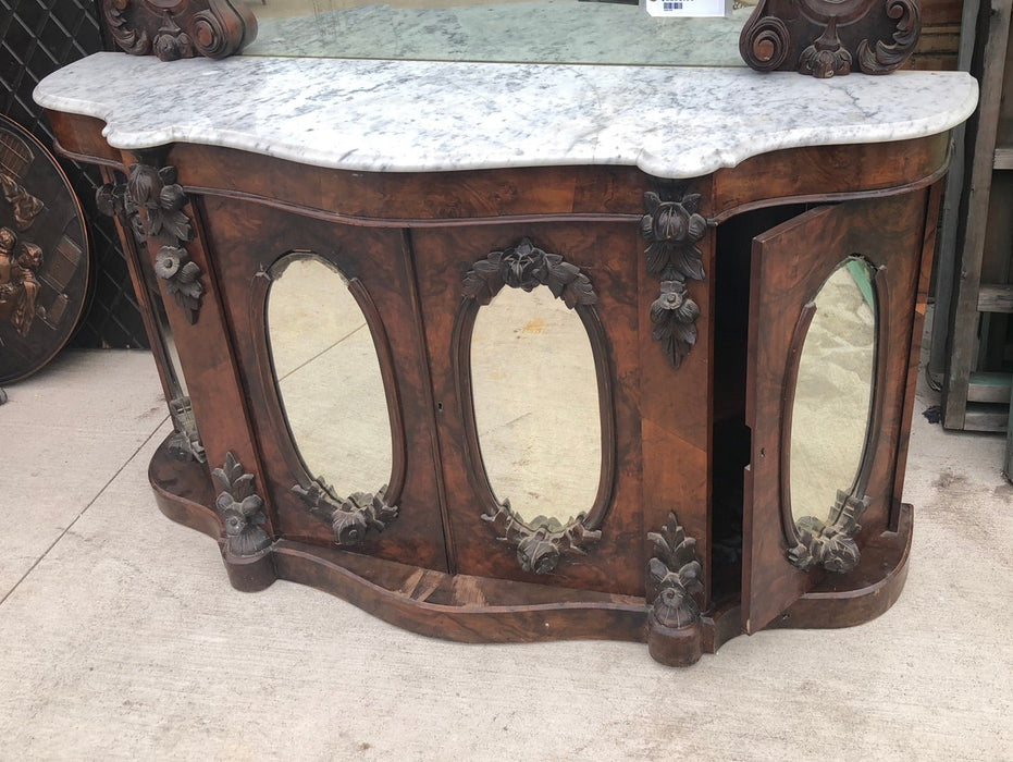 CURVED FRONT BURLED WALNUT SERVER WITH MIRRORED DOORS, CARVED MIRROR AND AS FOUND MARBLE TOP