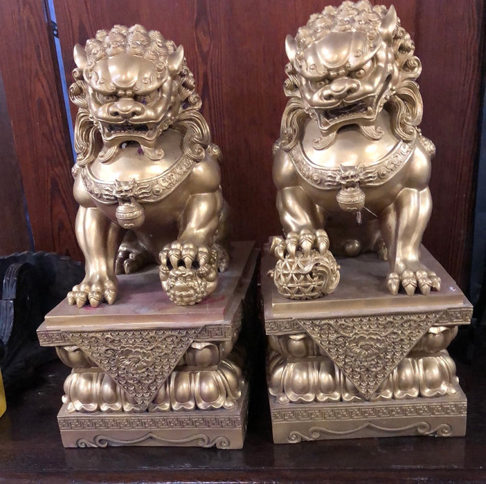 PAIR OF GILT FOO DOG SCULPTURES ON STANDS