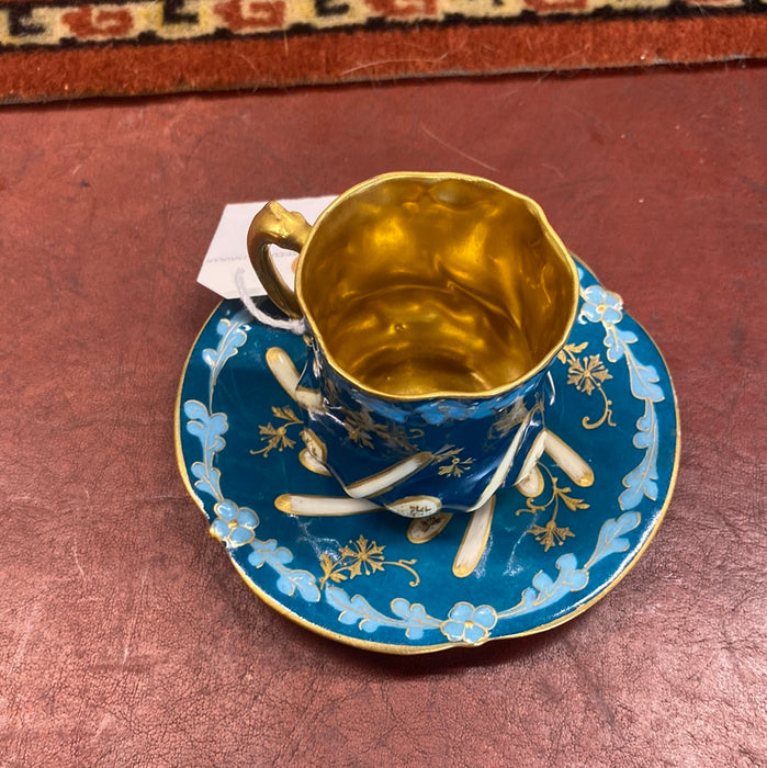 BLUE, GOLD, AND WHITE DEMITASSE CUP AND SAUCER