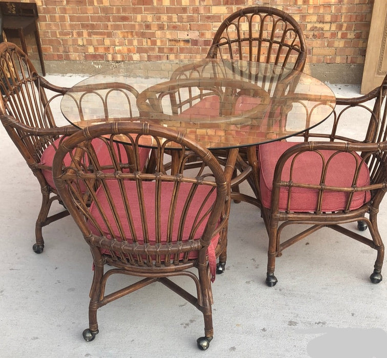 SET OF GLASS TOP RATTAN TABLE AND 4 MATCHING CHAIRS ON CASTERS