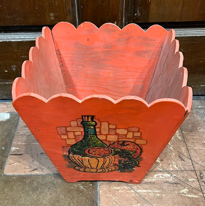 ORANGE PAINTED WOOD TRASH CAN WITH OLD WINE BOTTLE