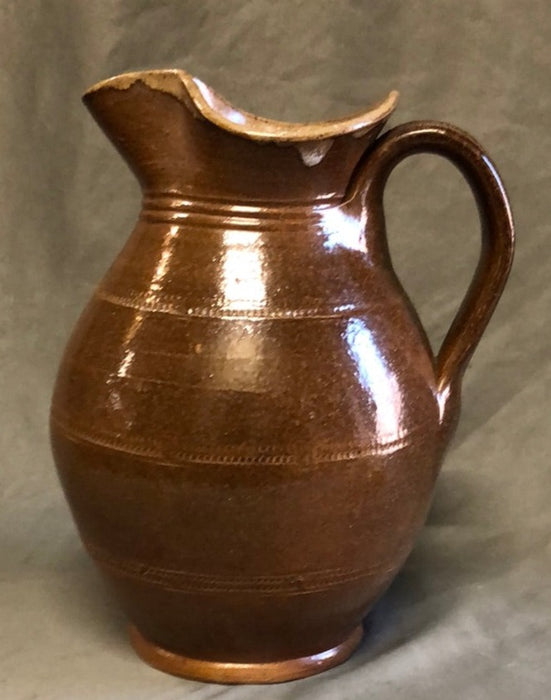 SMALL BROWN BULBOUS BASE HAND THROWN POTTERY PITCHER