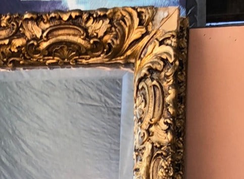 BEVELED GLASS MIRROR IN ORNATE GILT FRAME