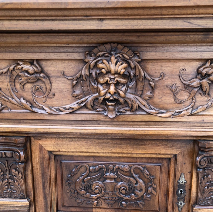 WALNUT GRIFFIN CARVED CABINET WITH CANTED ENDS