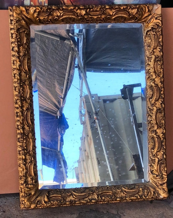 BEVELED GLASS MIRROR IN ORNATE GILT FRAME