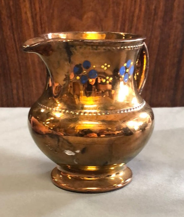 SMALL COPPER LUSTER CREAMER WITH BLUE FLOWERS