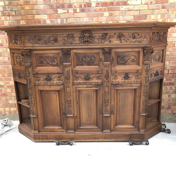 WALNUT GRIFFIN CARVED CABINET WITH CANTED ENDS