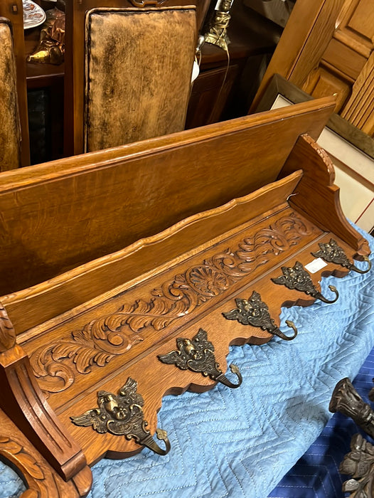 LIGHT OAK WALL SHELF WITH SHELLS AND CHERUB HOOKS