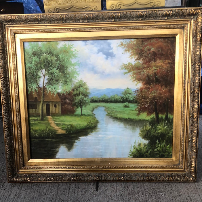 GILT FRAMED LANDSCAPE PAINTING ON CANVAS WITH YELLOW HOUSE