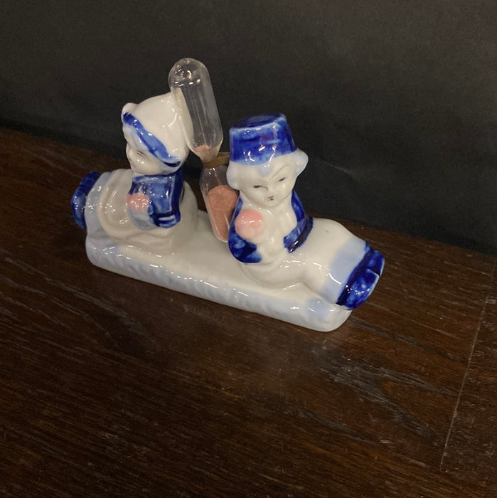 DELFT BOY AND GIRL WITH HOURGLASS FIGURINE