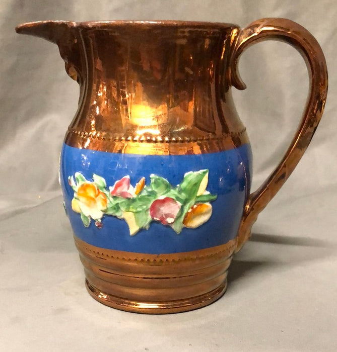 MEDIUM COPPER LUSTER PITCHER WITH BLUE BAND AND FLOWERS IN RELIEF