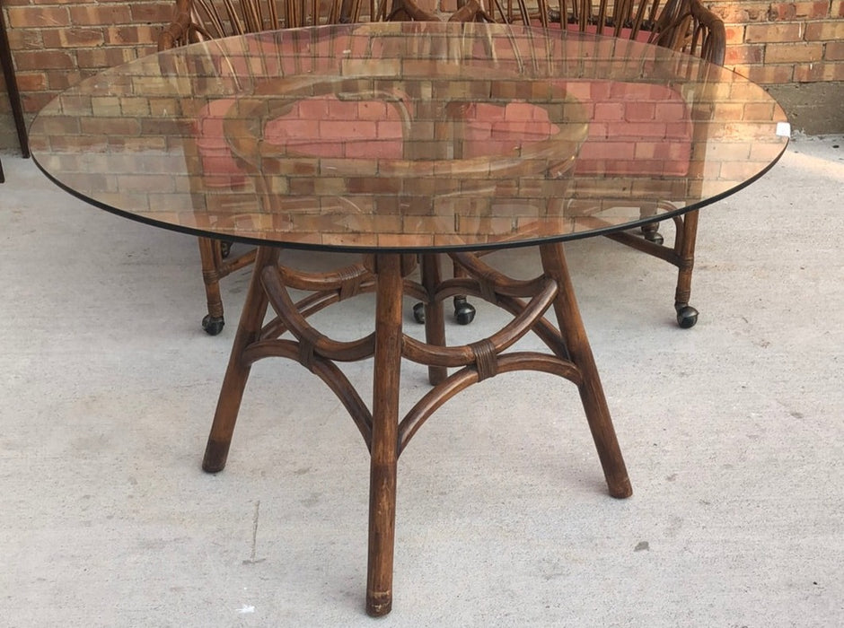 SET OF GLASS TOP RATTAN TABLE AND 4 MATCHING CHAIRS ON CASTERS