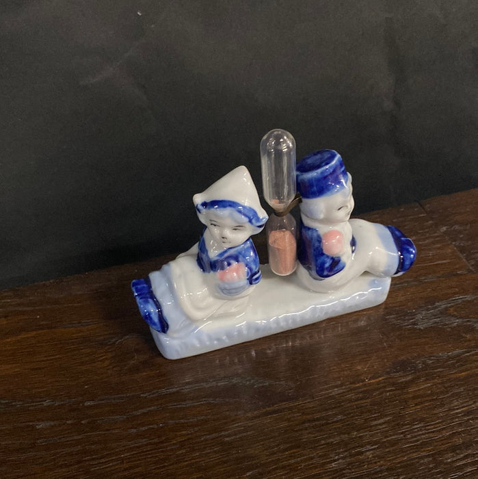 DELFT BOY AND GIRL WITH HOURGLASS FIGURINE
