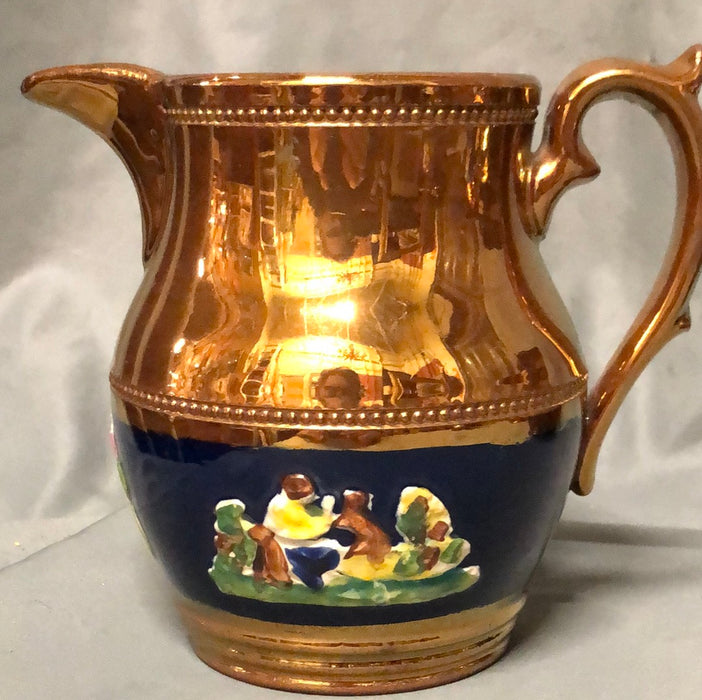 COPPER LUSTER PITCHER WITH MAN AND DOG